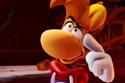 Rayman en primer plano apuntando con el dedo, en una escena de estilo animado