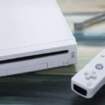 Consola Nintendo Wii junto a un Wii Remote blanco
